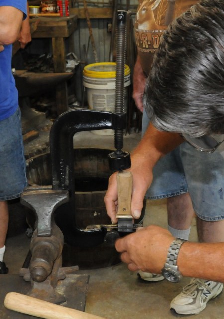 Placing blade in the jig after applying epoxy to tang